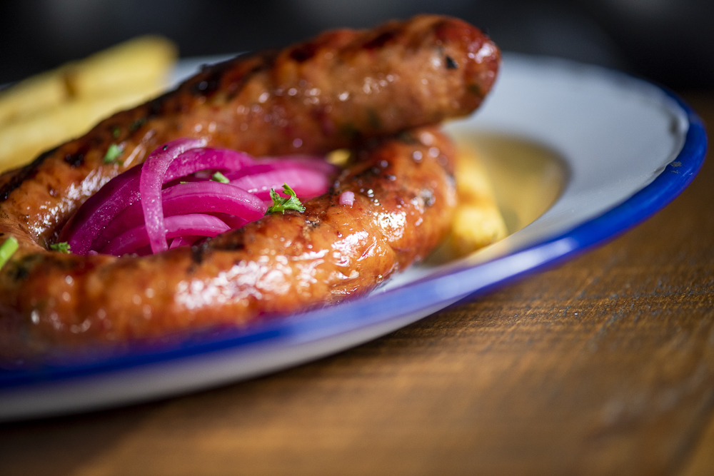 Smoked sausages with pickled red onion