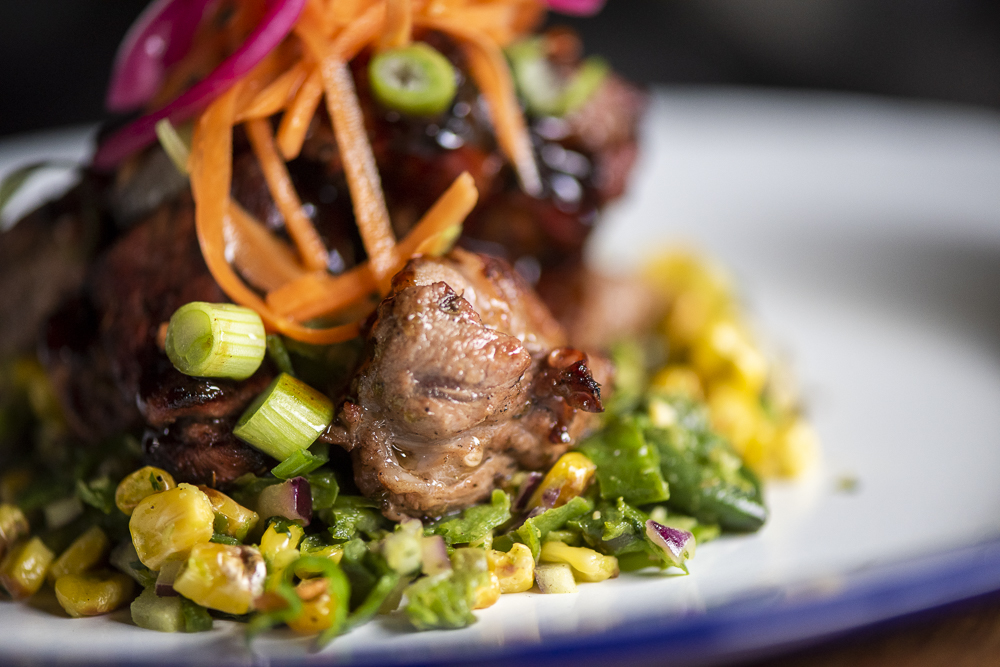 Smoked burnt ends with corn and spring onion