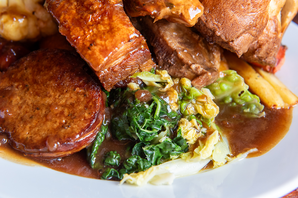 Sunday roast close-up with gravy and greens